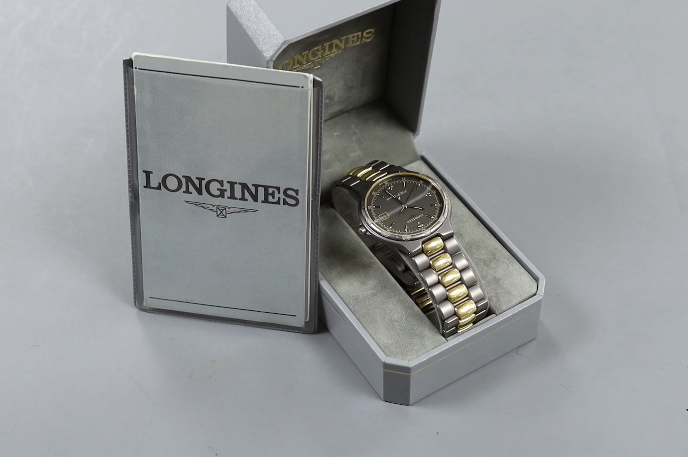 A gentleman's modern steel? and gold plated Longines TI VHP Quartz wristwatch, with box and some papers.
